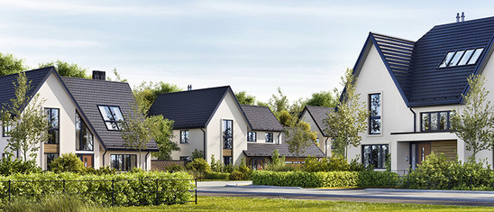 Mehrere Einfamilienhäuser blauer Himmer und viel Grün